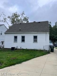 View of property exterior with a lawn