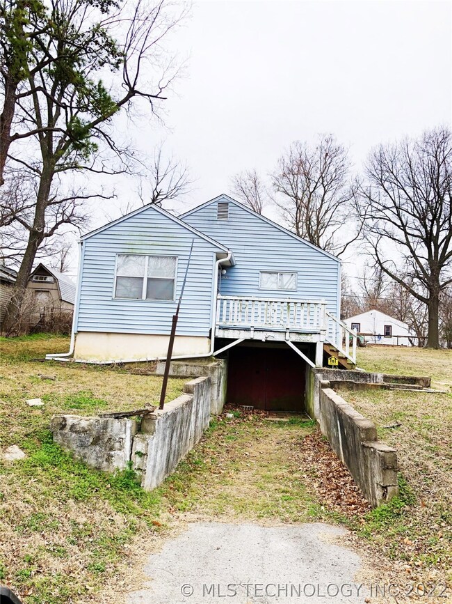 Area below the front porch leads into the basement