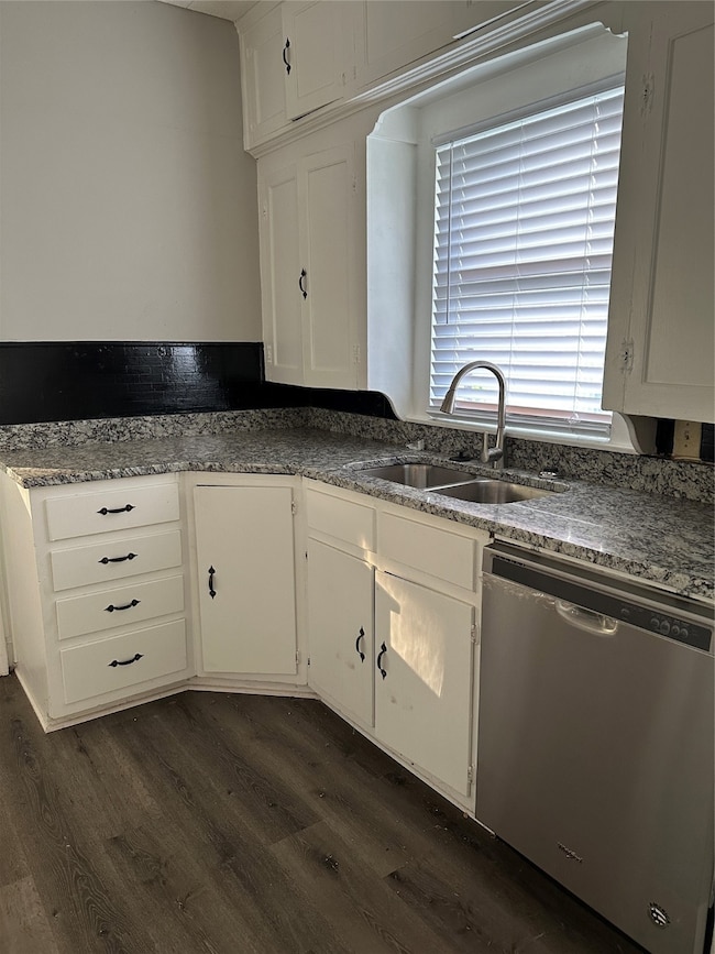 Kitchen with dishwashing machine, white cabinetry, and dark wood-type flooring