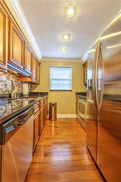 Modern kitchen featuring maple cabinets, hardwood 