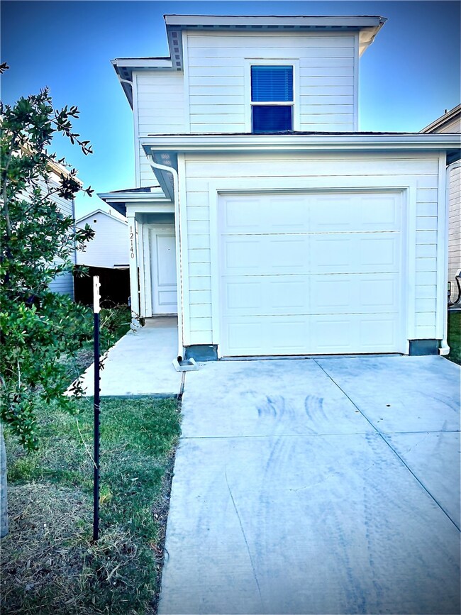 Traditional-style house with a garage and concrete driveway