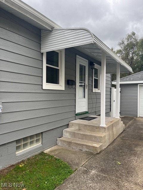 Doorway to property with a garage