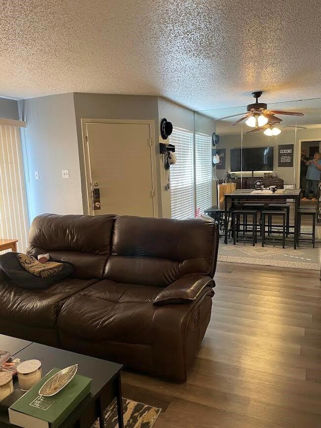 Living room featuring a textured ceiling, a ceilin