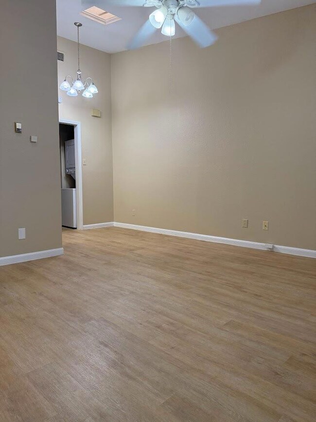 Unfurnished room featuring ceiling fan, light woo