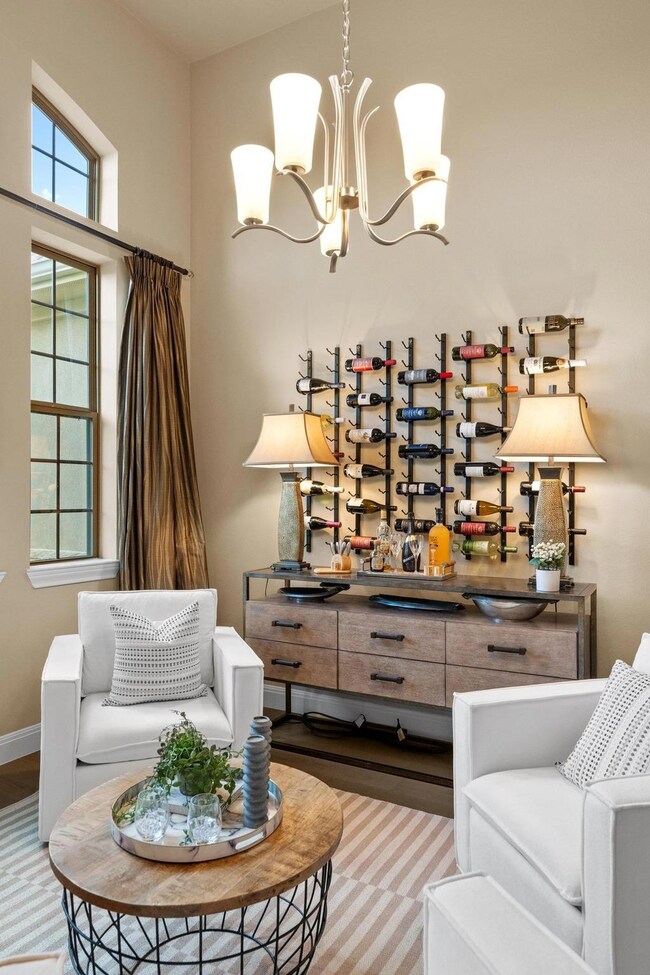 Living area featuring a chandelier and wood finis