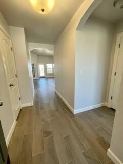 Hallway featuring dark wood-type flooring