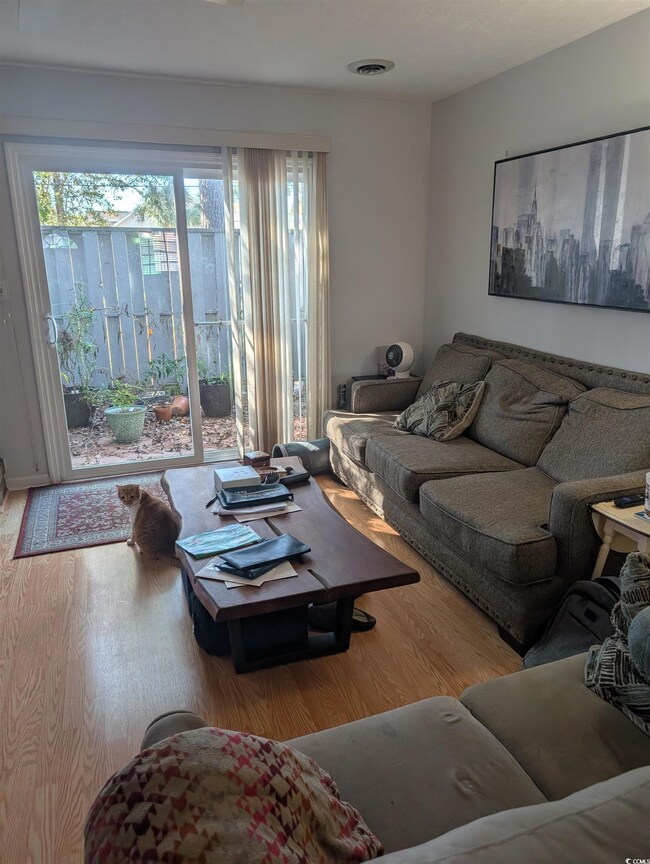 Living room with hardwood / wood-style flooring