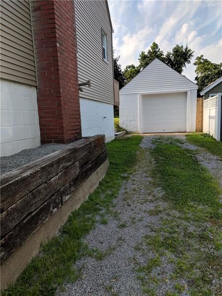 Long driveway leading to the one car garage