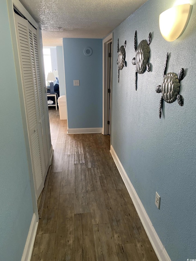 Hall featuring dark hardwood / wood-style floors a