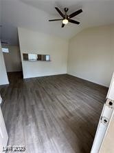Unfurnished living room with lofted ceiling, dark wood-style floors, and ceiling fan