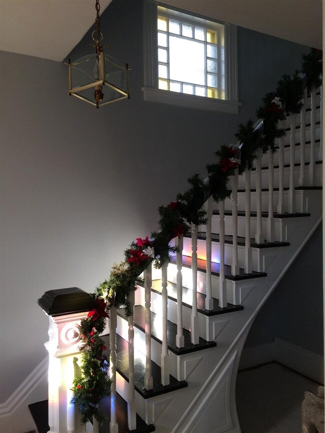 This stairwell is flanked by a beautiful stained g