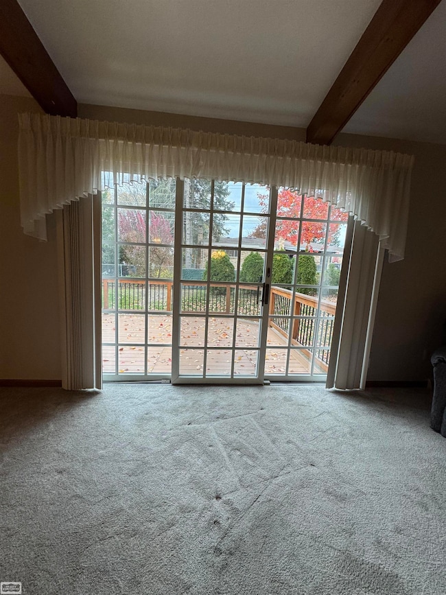 GREATROOM WITH ANDERSON DOOR WALL LEADING TO LARGE MAINTNESS FREE DECK