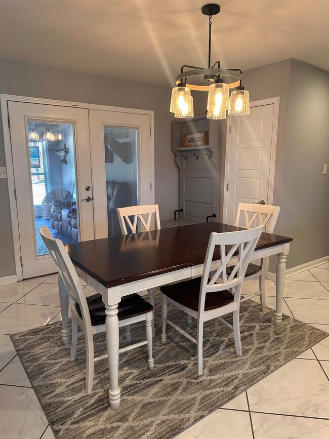 Dining space with french doors, marble finish floo