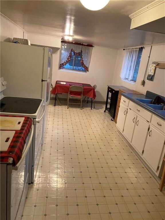 Kitchen with white appliances and white cabinetry
