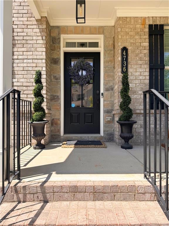 Entrance to property featuring stone siding and co
