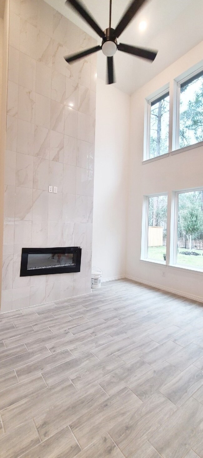 Luxury fireplace in family room with porcelain tile going all the way up.