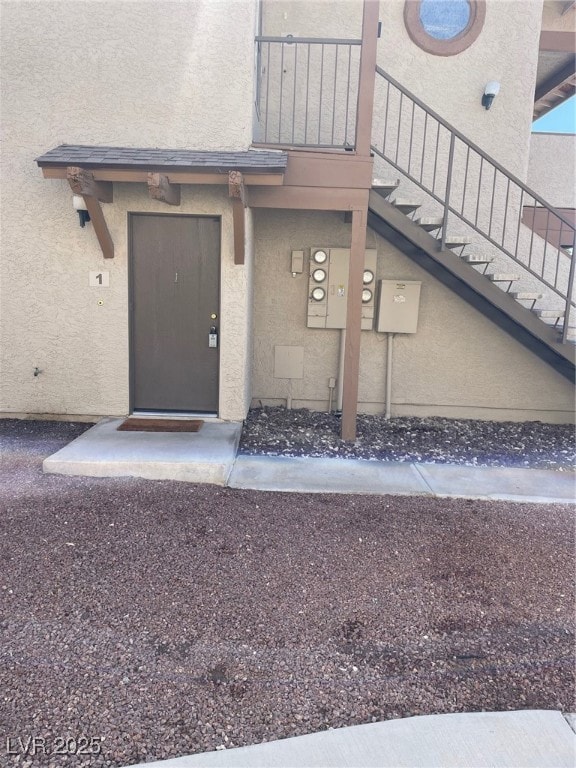 Property entrance featuring stucco siding