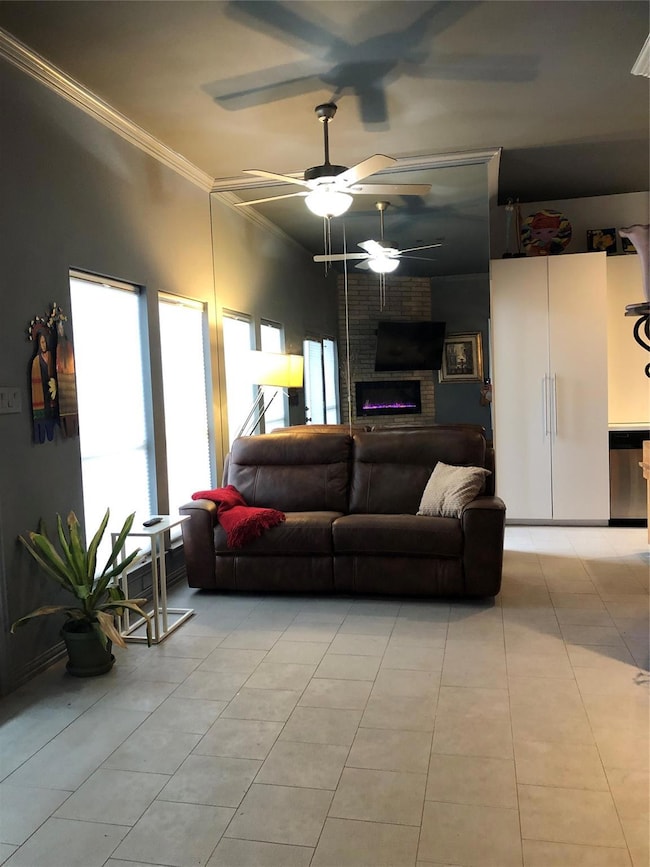 Living area with crown molding, a brick fireplace,