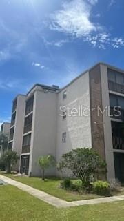 Side view of condo building with great curb appeal