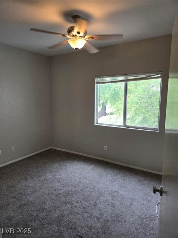 Empty room featuring carpet, ceiling fan, and baseboards