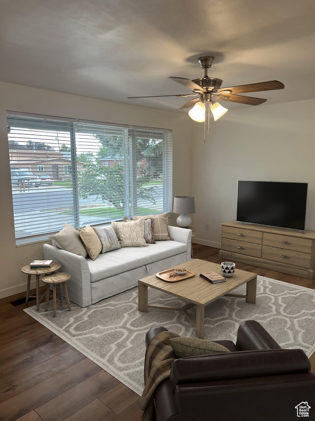 Living room featuring wood finished floors and a ceiling fan