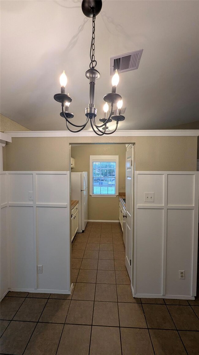 Kitchen featuring freestanding refrigerator, a ch