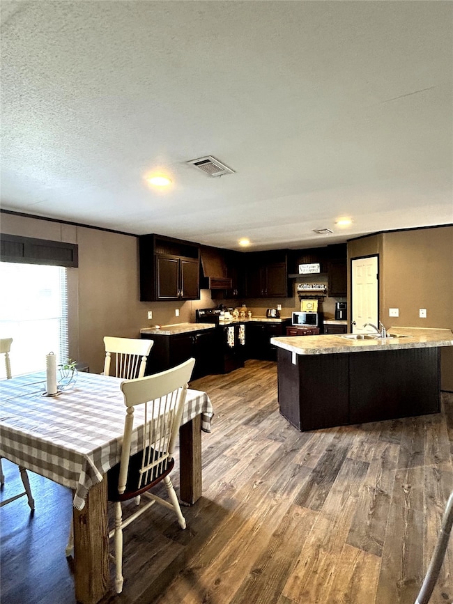 Large kitchen with rich cabinetry, expansive count