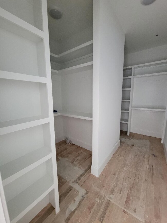 INCREDIBLE primary closet with so many shelves! Custom closets throughout