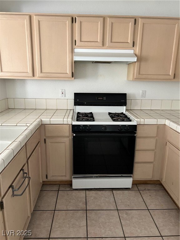 Kitchen with light tile patterned floors, light br