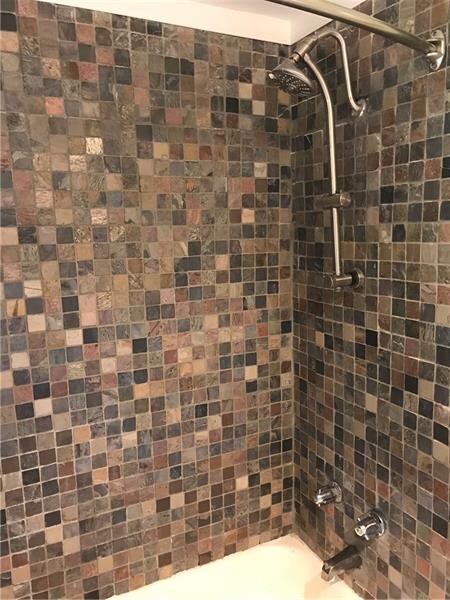 Tiled shower stall and newer shower head installed
