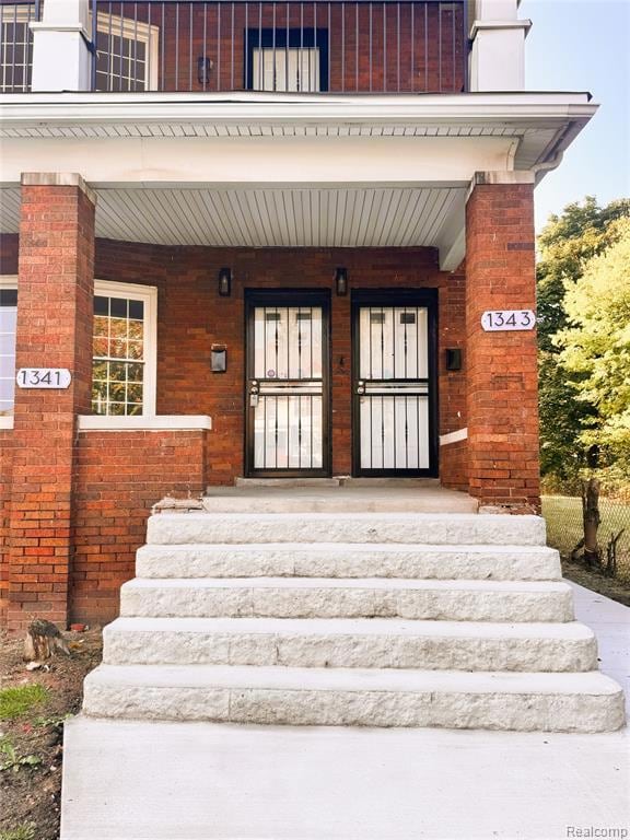 Entrance to property featuring a porch