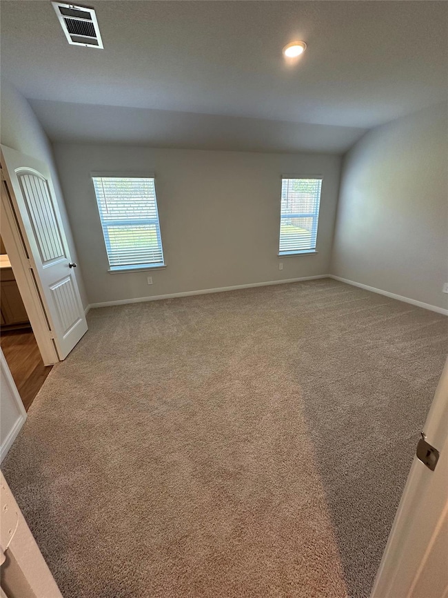 Empty room with carpet flooring, baseboards, and 