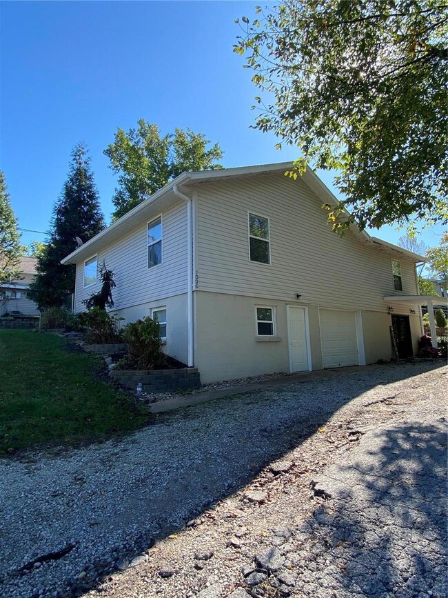 Raised ranch with one car garage/workshop and family room on entry level.