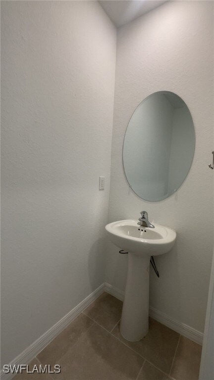 Bathroom with tile patterned floors and a sink