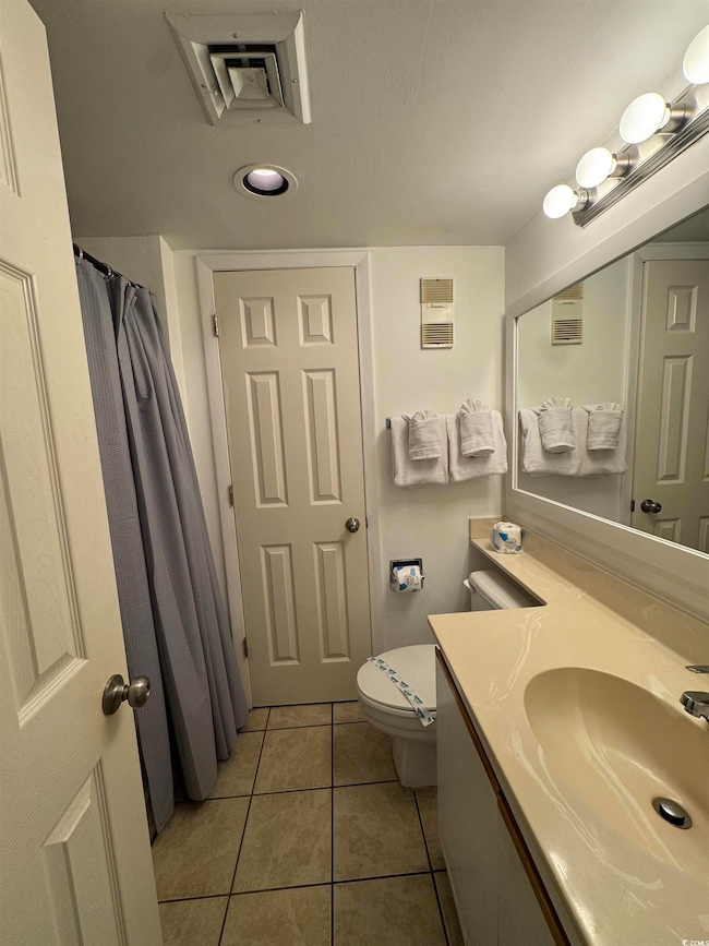 Bathroom featuring tile patterned floors, toilet, 