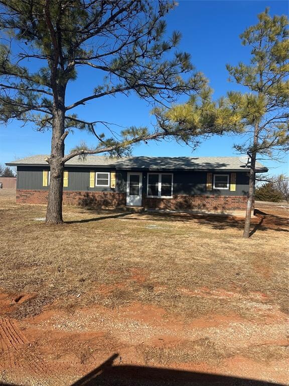 Ranch-style home featuring a front lawn