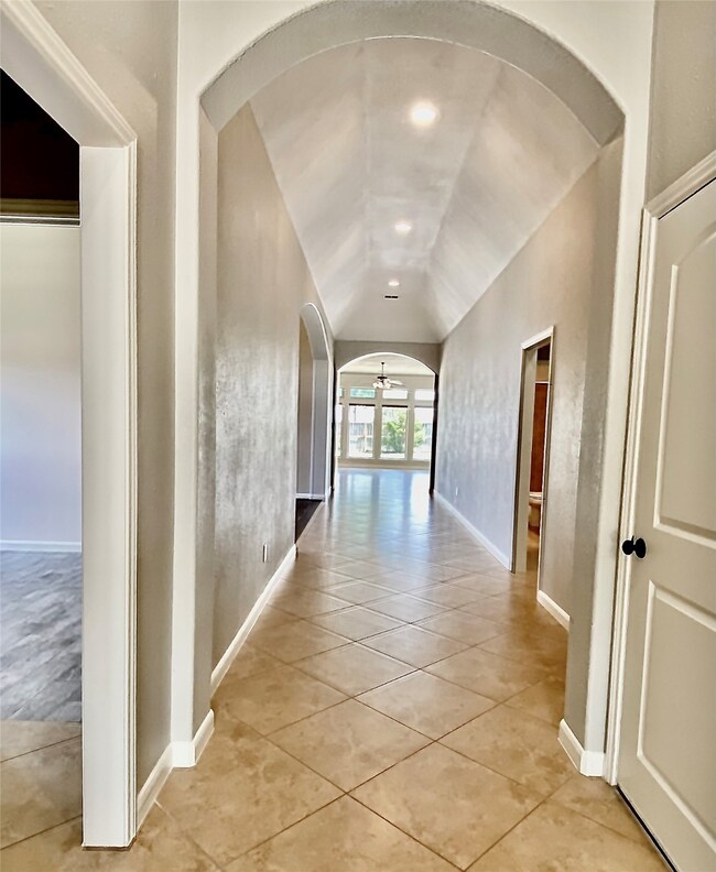 Jr En-suite (L) and 3 car garage (R). Just before you walk past the secondary bedrooms and bath to your Formal Dining.
