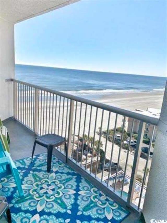 Balcony with a water view and a view of the beach