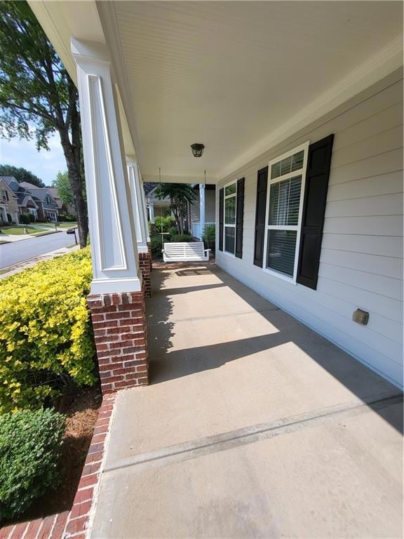 Adorable covered front porch with swing.