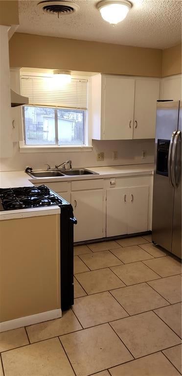 Kitchen featuring stainless steel refrigerator wi