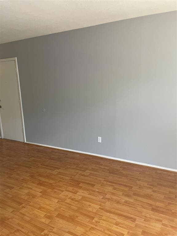 Unfurnished room with light wood-style flooring a