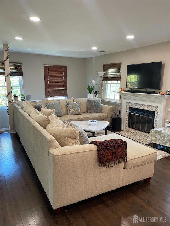 Spacious Living room with hardowod floors and recessed lights.