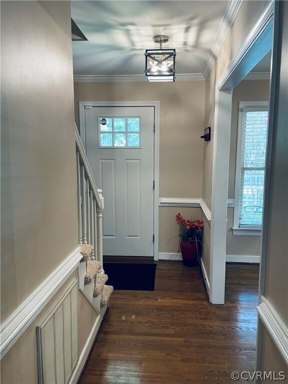 Entrance with hardwood floors and new light fixtur