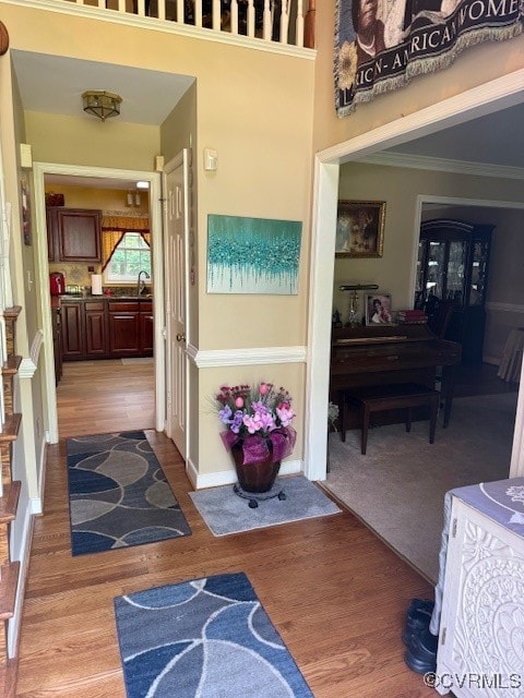 Foyer entrance with light wood finished floors and
