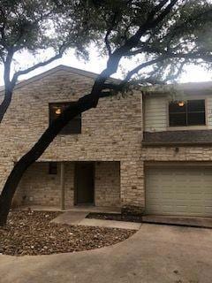View of front facade featuring concrete driveway and a garage