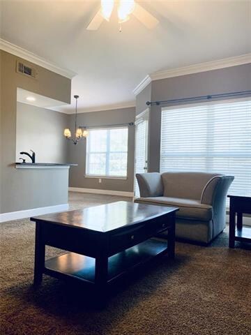 Living room is open with large windows for natural