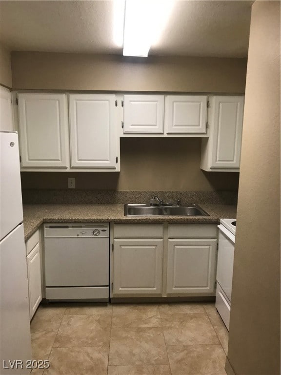 Kitchen with dishwashing machine, white cabinetry,