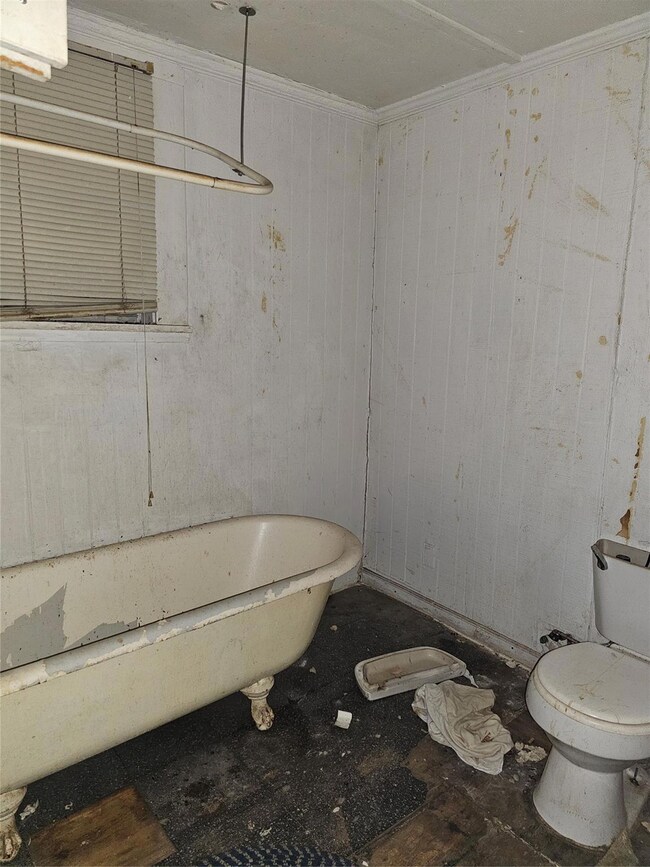 Bathroom with a washtub and toilet