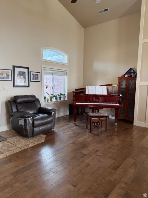 Sitting room with high vaulted ceiling and dark wood finished floors