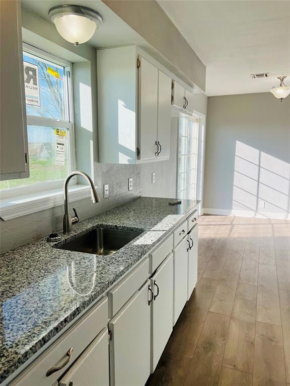 Kitchen with sink, light stone countertops, plenty